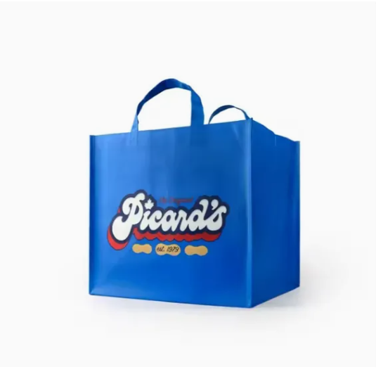 Bright yellow non-woven drawstring bag, trendy style, placed on light wooden surface